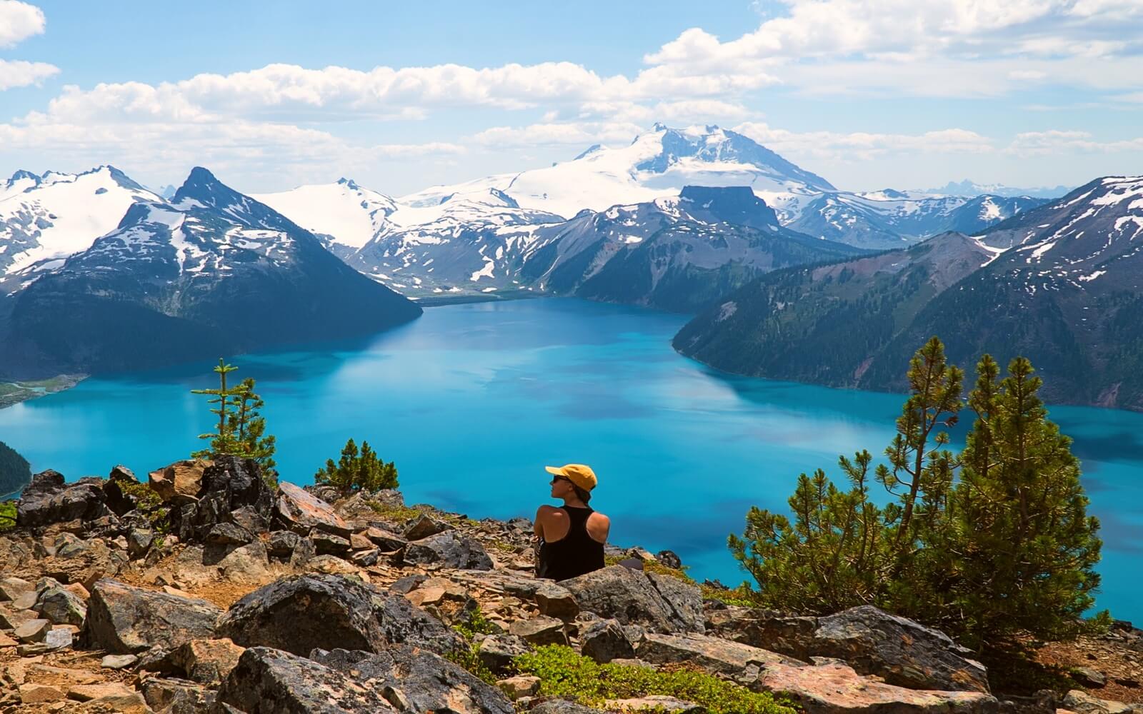 A woman admires the view of Garibaldi Lake