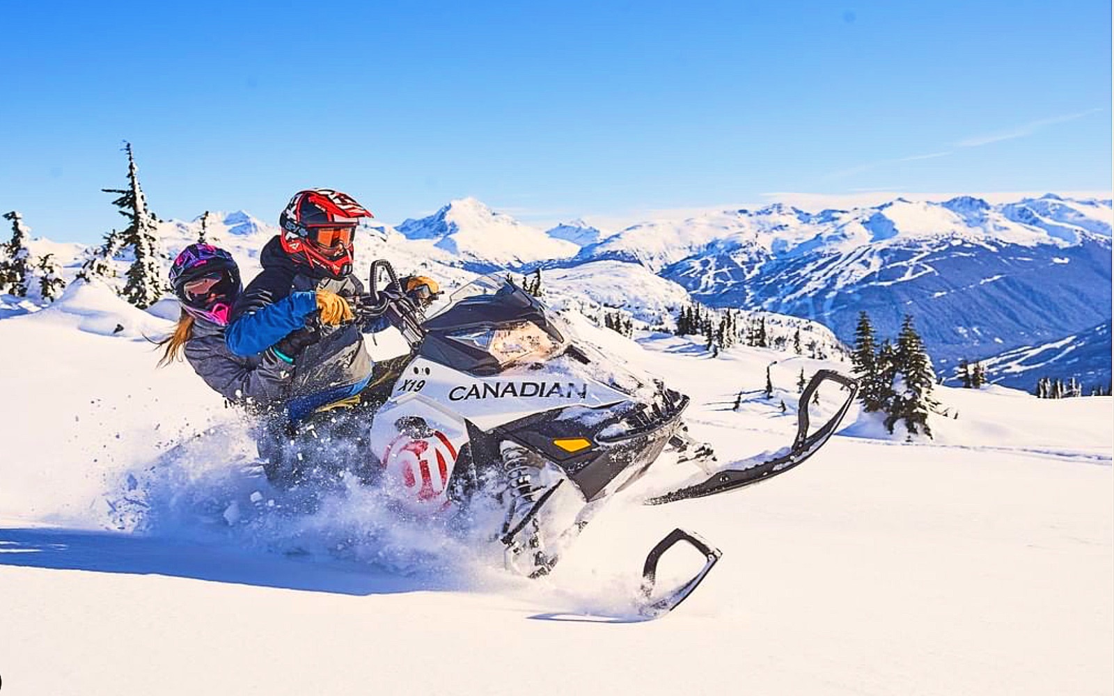 A pair of snowmobilers plow through the Coast Mountains
