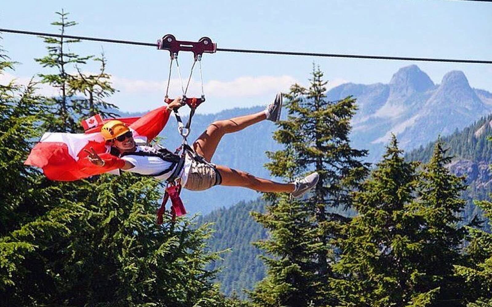 A woman ziplines at Grouse Mountain on Canada Day