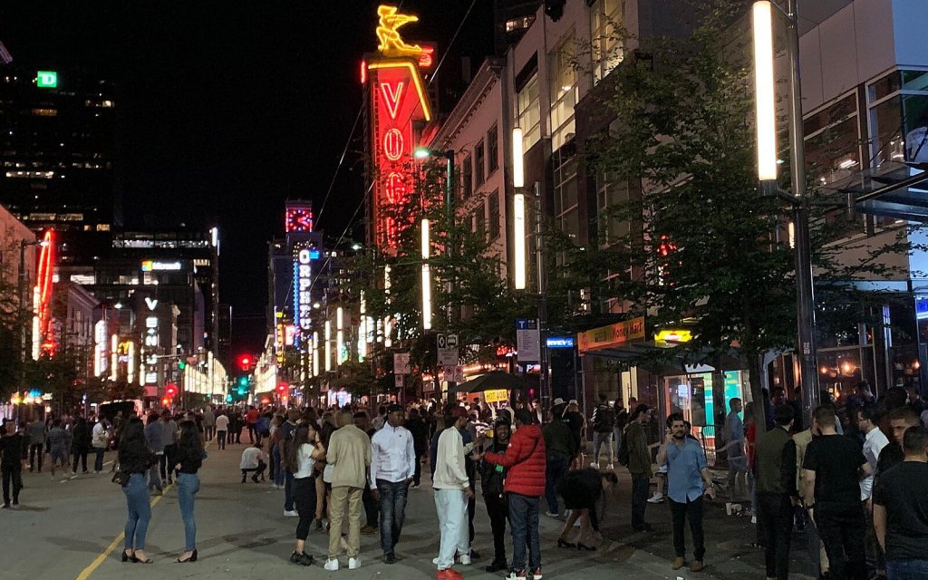 a crowd forms outside the bars on granville street in vancouver bc