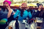 Three girls take shots off the shot-ski at the Longhorn Saloon