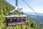 tourists riding the grouse mountain skyride to the top of grouse mountain with vancouver city view