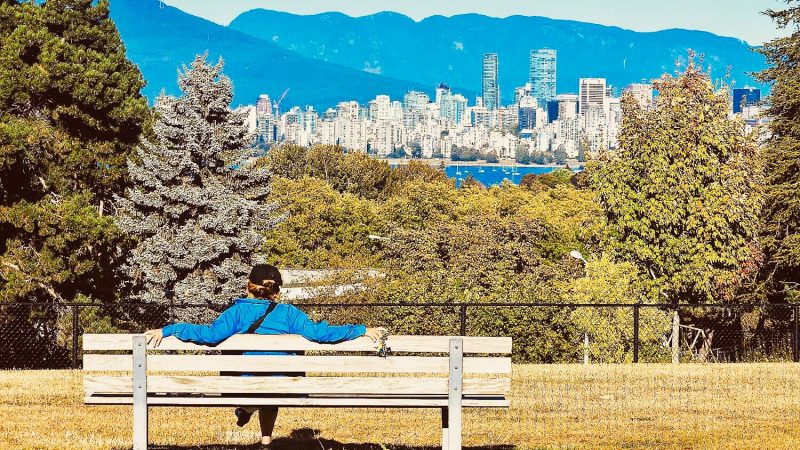a woman enjoys one of the best parks in vancouver.