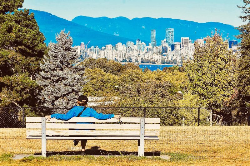 a woman enjoys one of the best parks in vancouver.