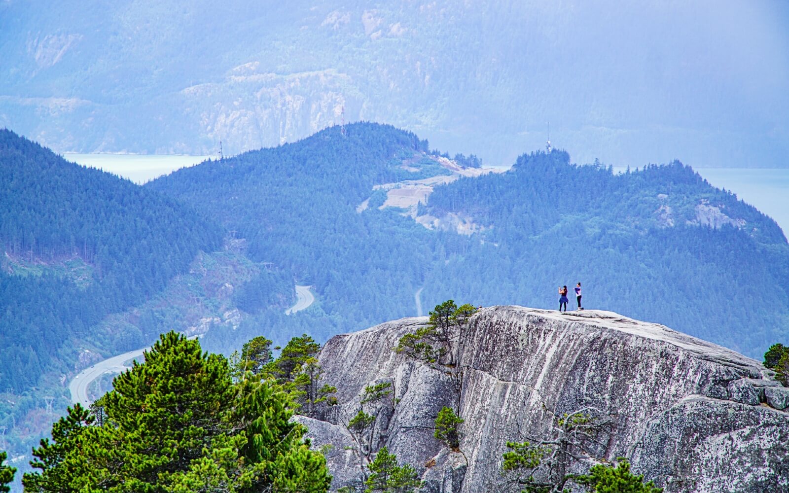 hikers atop the stawamus chief in squamish bc