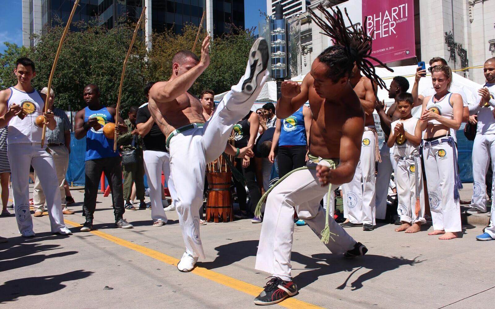 capoeira fighters doing a demonstration at the carnaval del sol in vancouver bc canada