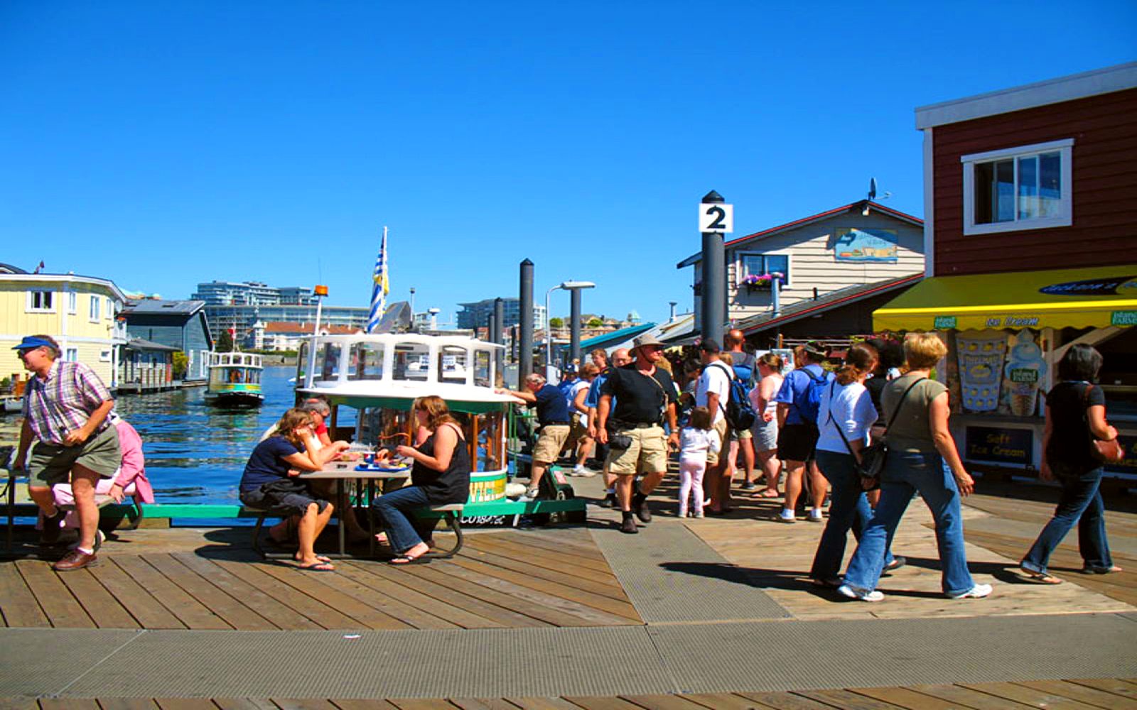 tourists dine at Fisherman's Wharf, Victoria BC