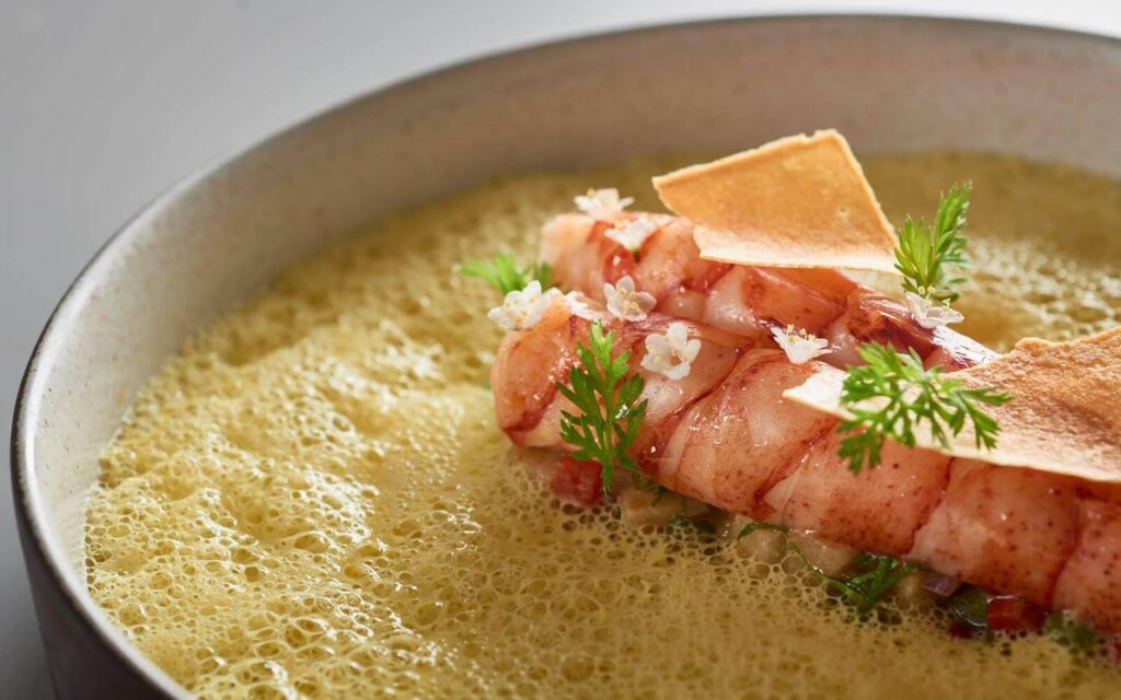 a poached prawn at hawksworth restaurant in vancouver