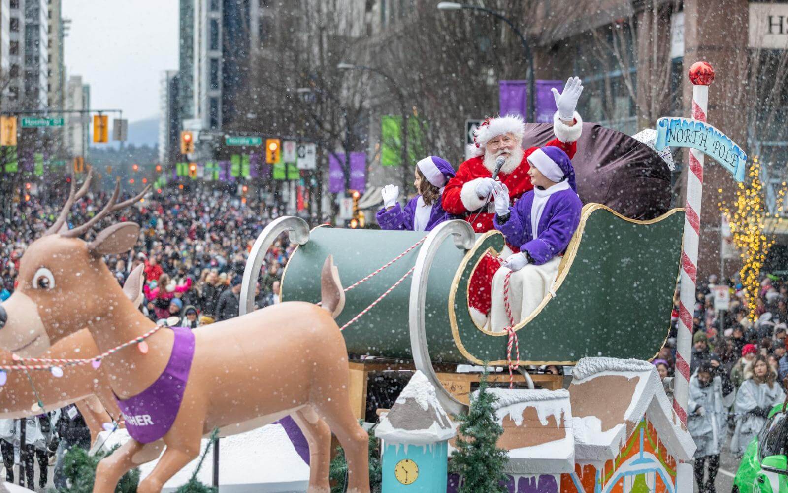 santa claus riding a float in the snow during the vancouver santa claus day parade