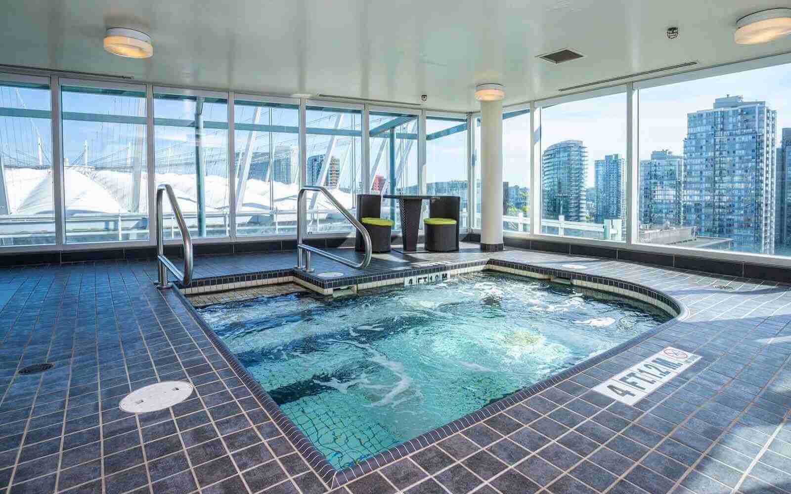 a pool with skyline view at the hampton inn suites in vancouver