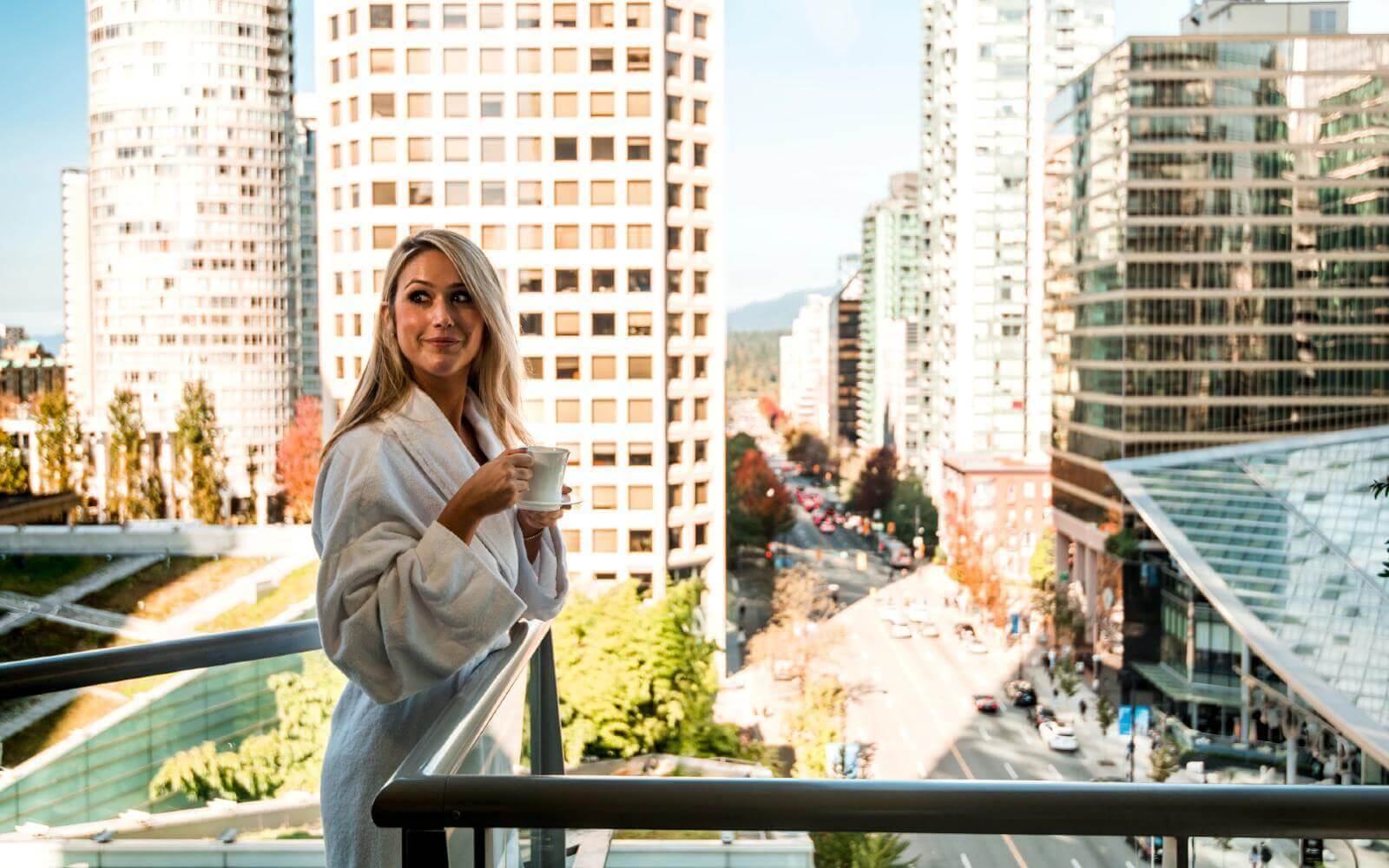 a woman having coffee on the balcony at the shangrila hotel in vancouver canada