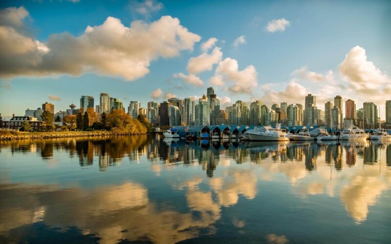 clouds reflecting in the water outside stanley park with vancouver skyline in september