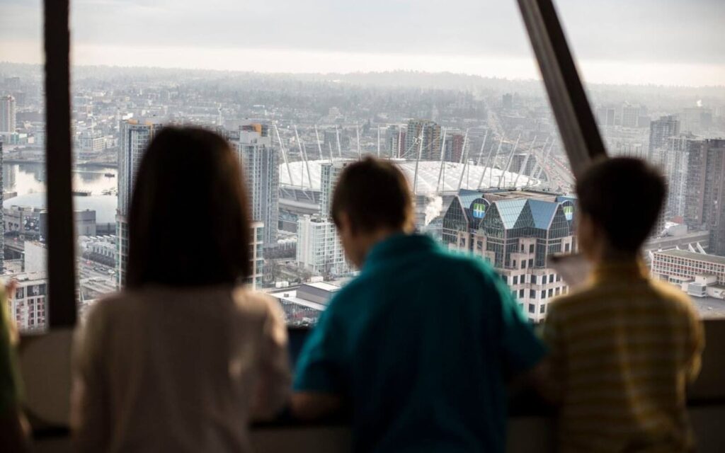 kids looking down on the vancouver skyline from the vancouver lookout tower