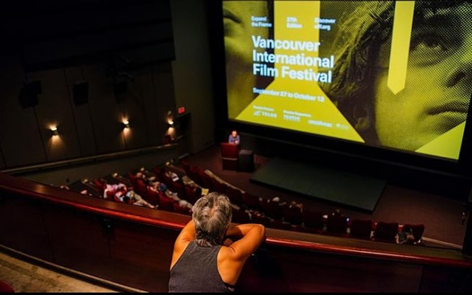 A women watches a film at the vancouver international Film festival