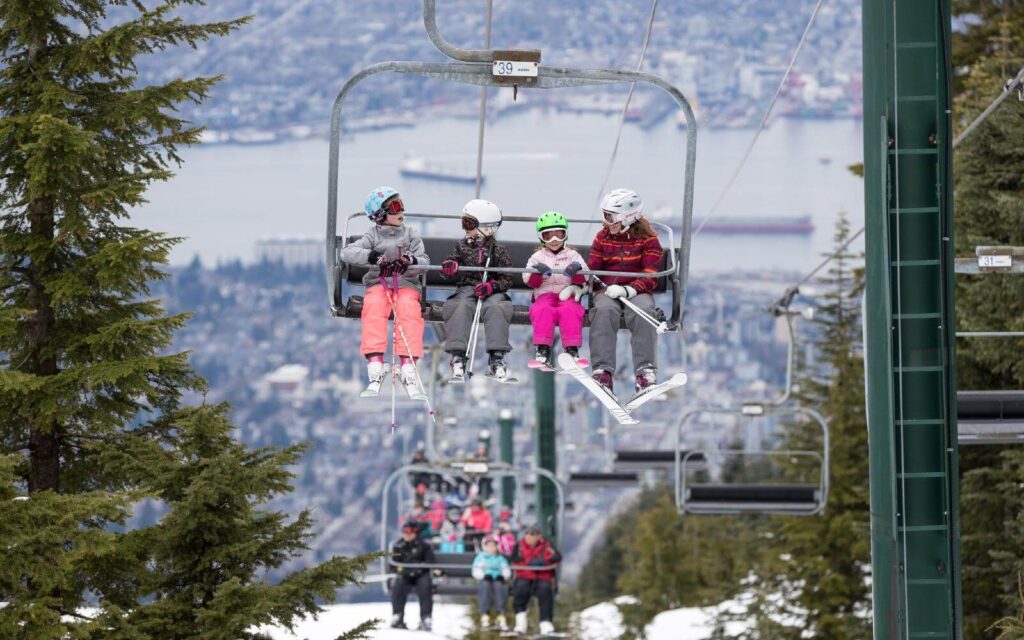 kids on a chairlift at grouse mountain in vancouver bc canada