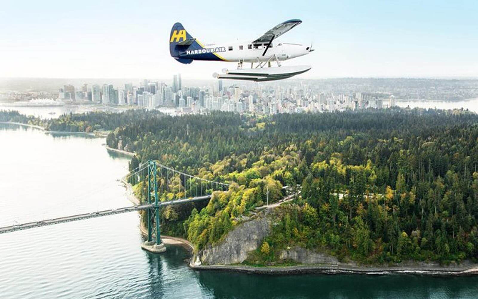 a vancouver to victoria seaplane flying over downtown vancouver with stanley park