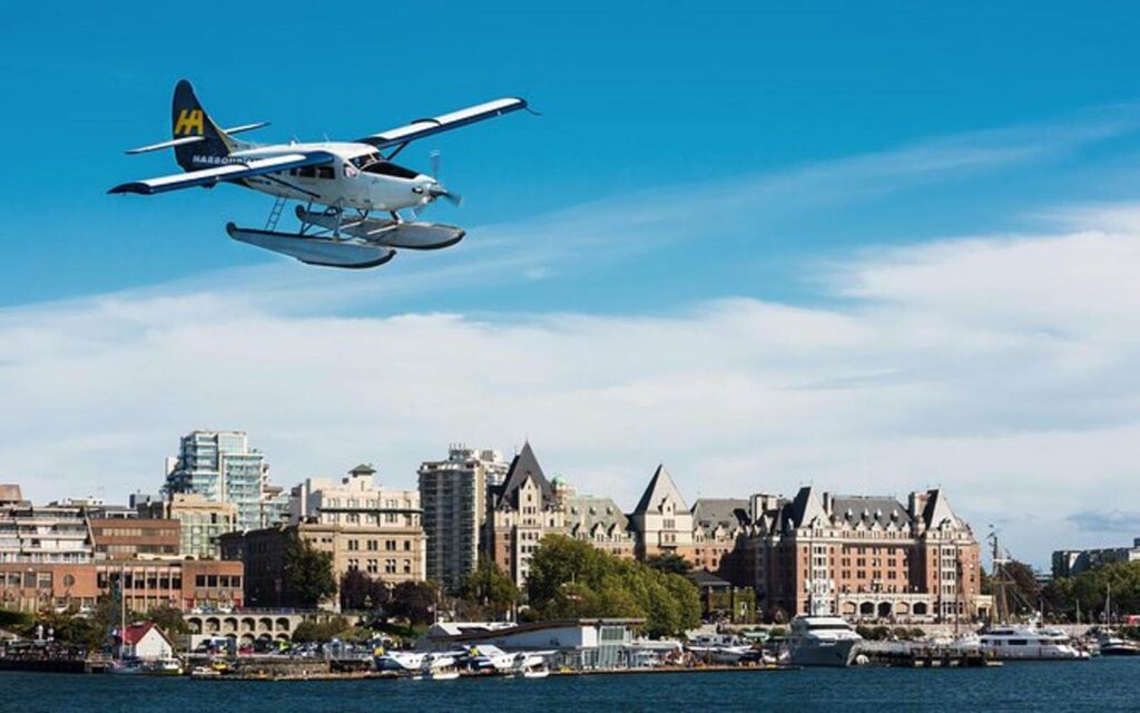 a vancouver to victoria seaplane flying over downtown victoria with the empress hotel