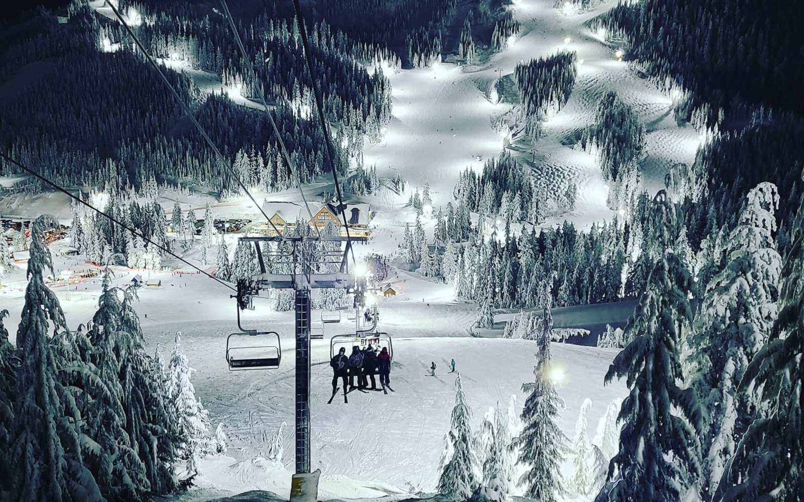 night skiers on a chairlift at cypress mountain ski ill