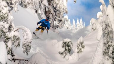 a skier barreling through powder at mount seymour ski resort in vancouver bc canada