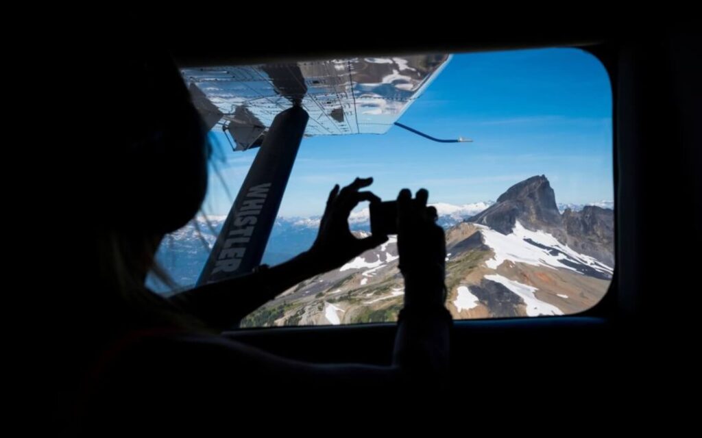 passengers taking a photo of the glacier on the vancouver to whistler flights