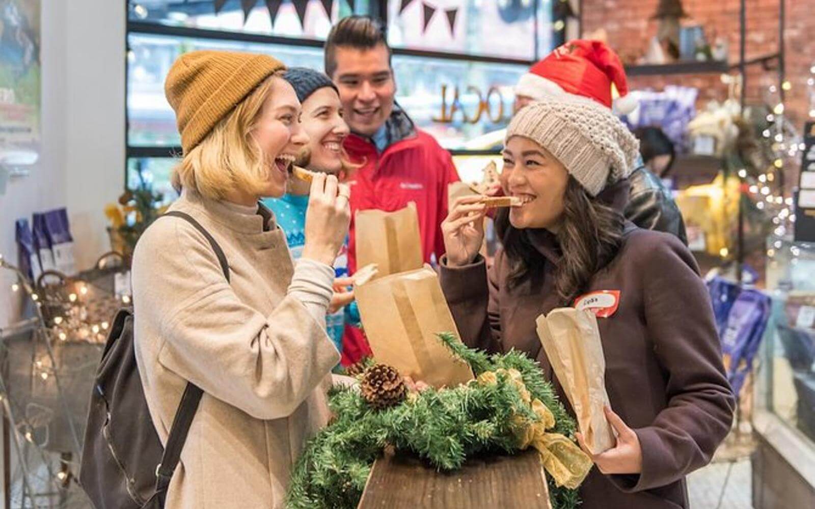 holiday guests eating treats at a christmas market tour of granville island