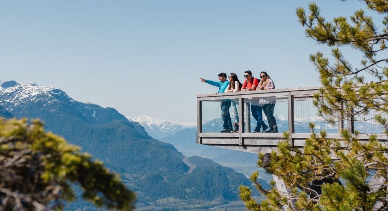 visitors standing at a viewpoint at the sea to sky gondola in squamish bc