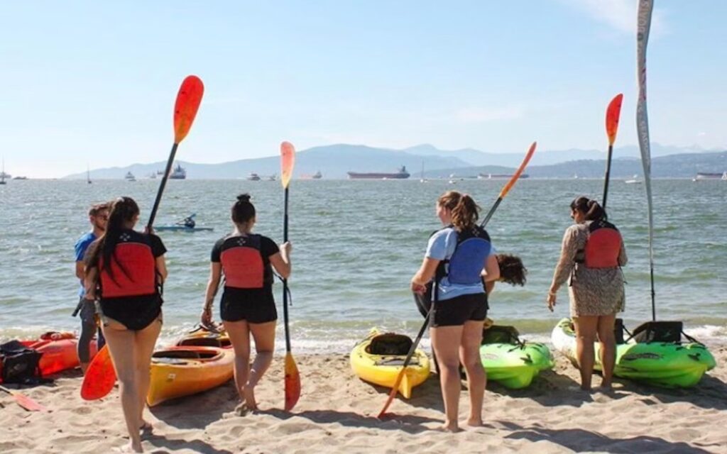 a group preapres to enjoy kayaking in vancouver, bc.
