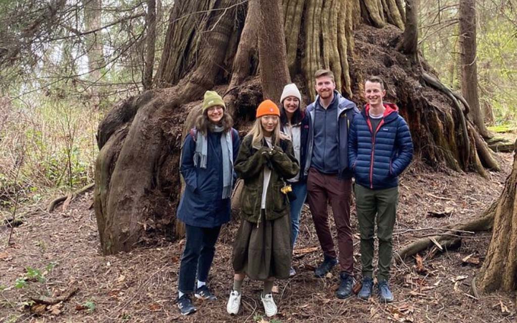 group of people in front of an ancient tree on a vancouver walking tour in vancouver bc canada