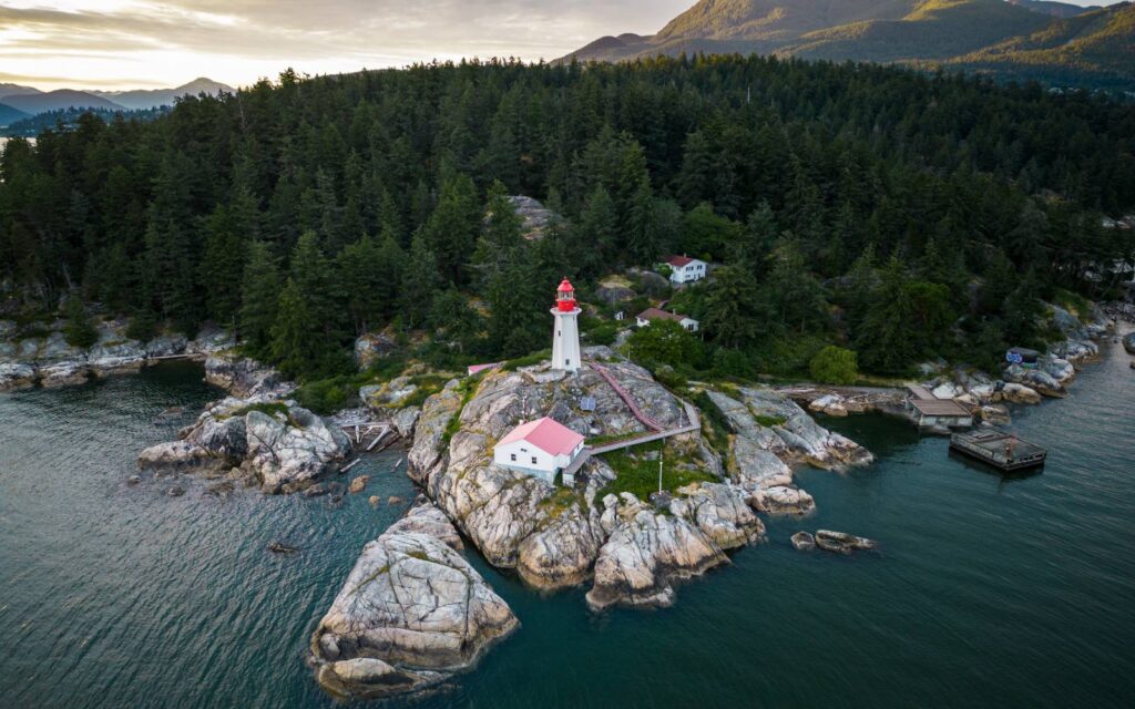 a drone shot of the point atkinson lighthouse in west vancouver's lighthouse park