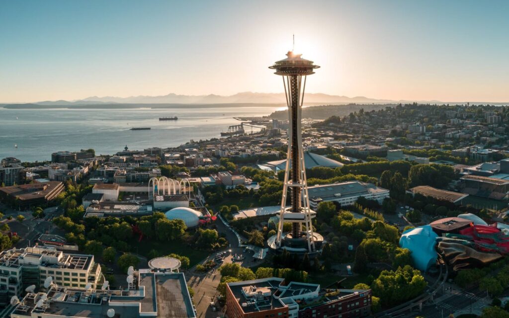 a view of puget sound with the space needle in the foreground