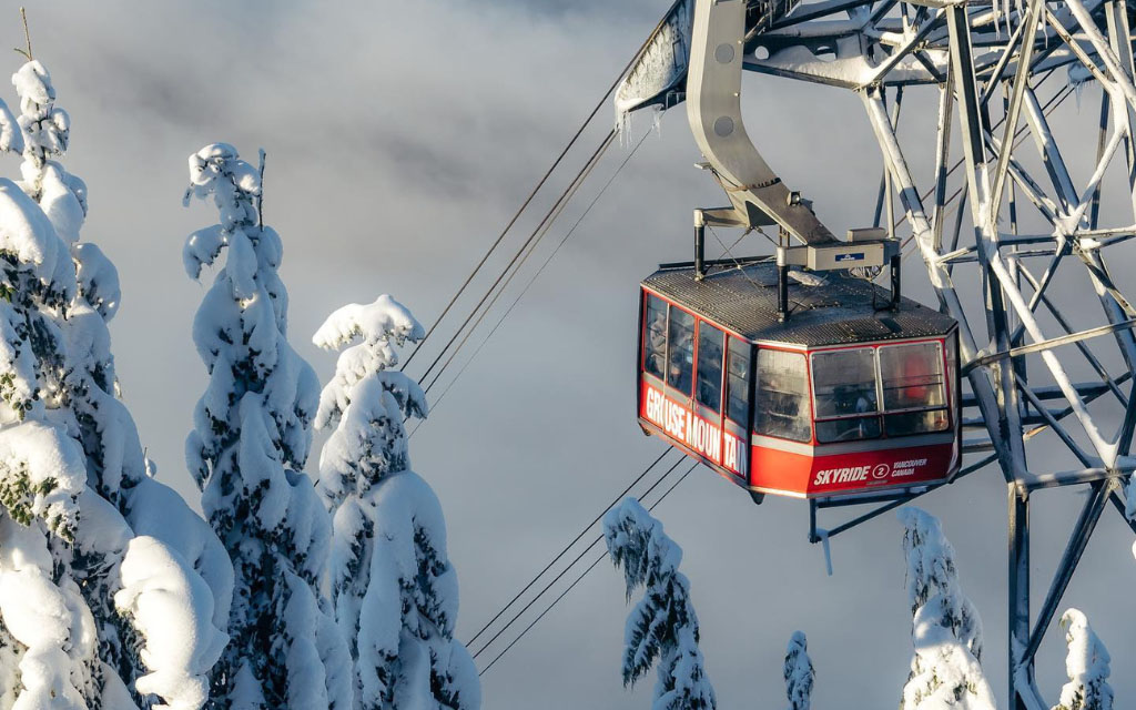 snowy trees and the grouse mountain skyride during winter in vancouver bc canada