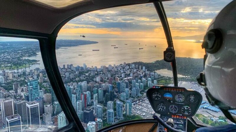 a vancouver helicopter tour flies over the city skyline