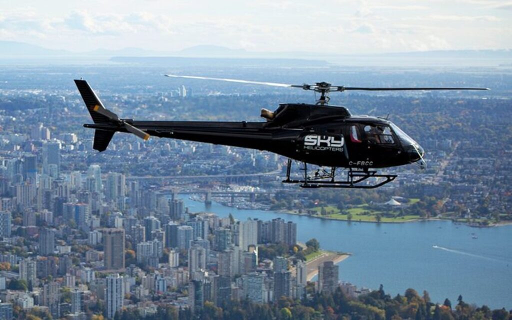 a helicopter flies over the vancouver skyline