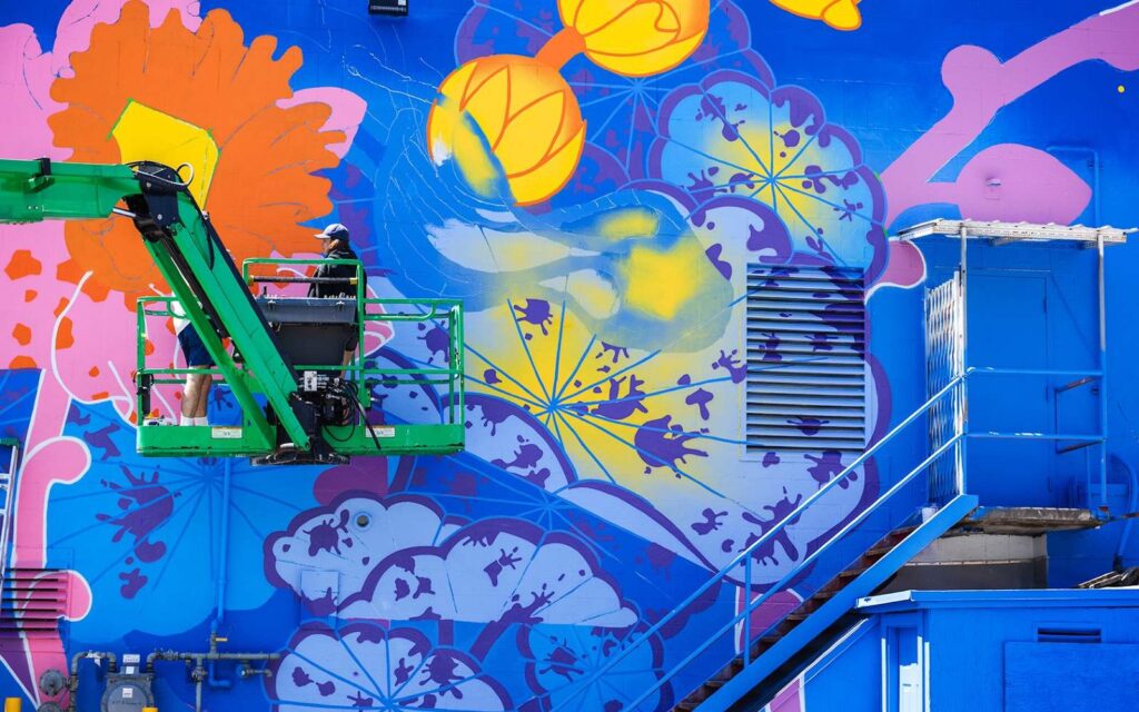 artists decorating a mural in vancouver bc