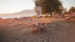 a bike tied to a post at english bay beach in vancouver bc