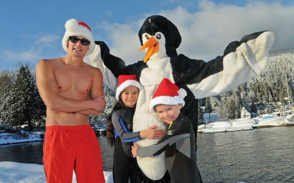 a family joining the penguin plunge at deep cove in vancouver bc canada