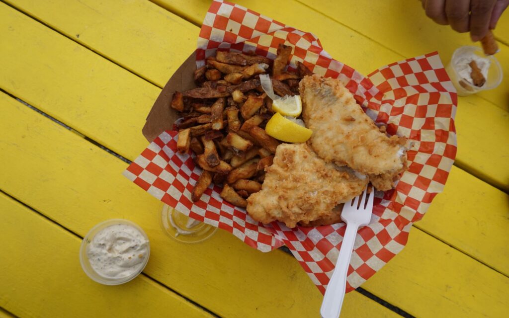 a serving of fish and chips at a seaside restaurant.