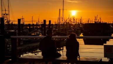 a couple ponder the richmond, bc things to do while sitting at the docks in steveston village.