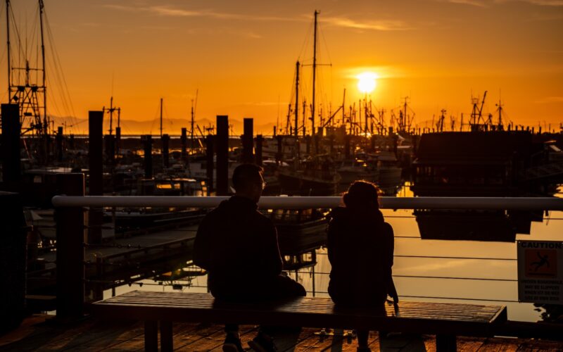 a couple ponder the richmond, bc things to do while sitting at the docks in steveston village.