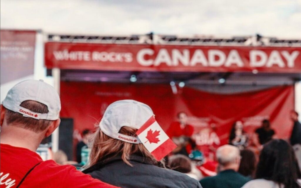 a couple enjoys the festivities on canada day in white rock, bc.