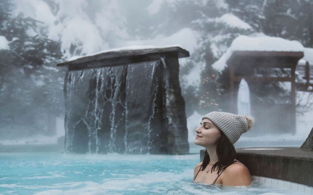 a woman relaxes in a thermal spa at the scandinave spa in whistler, bc.