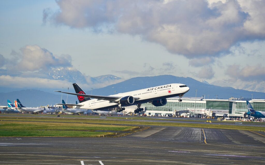 an air canada jet takes off at yvr airport.