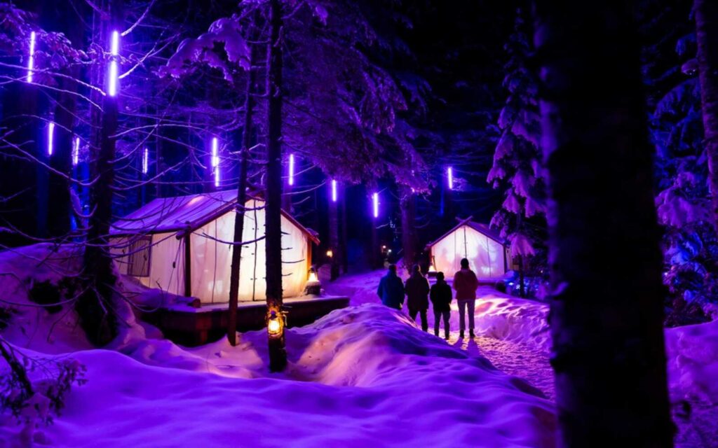 4 people standing and appreciating the experience in vallea lumina with snowy scenery