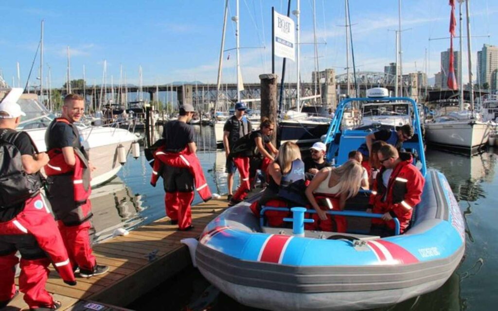 group of people getting ready on a vancouver city and seals scenic boat tour wearing their life jackets 