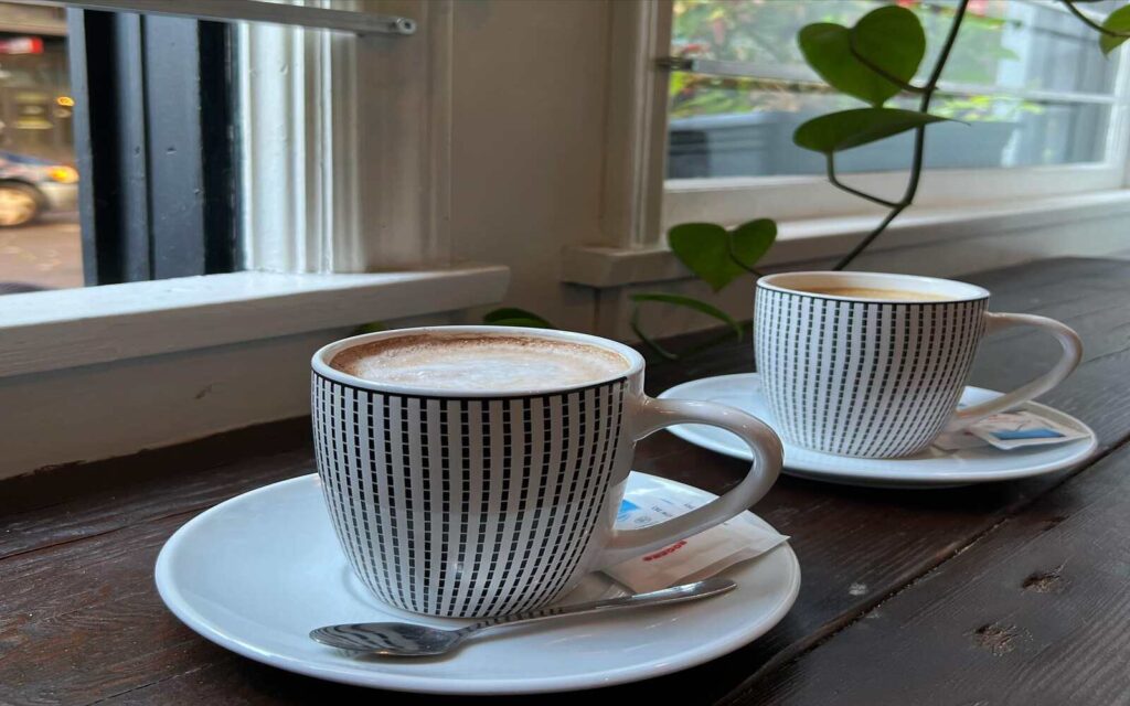 two coffee on white and black mugs at brioche ristorante and catering 