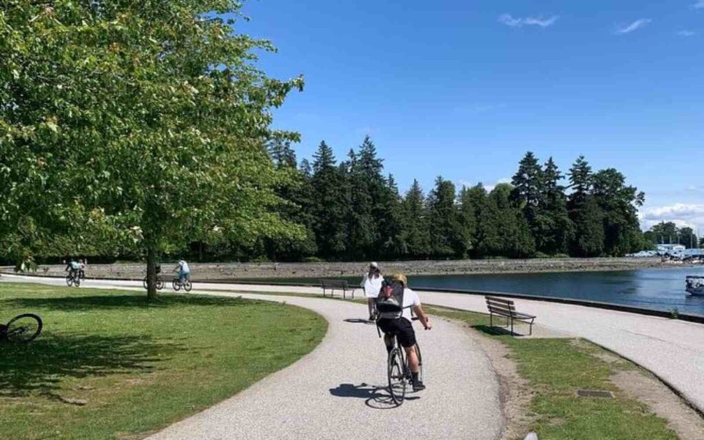 cycling during bike and hike tour in vancouver with full gear on 