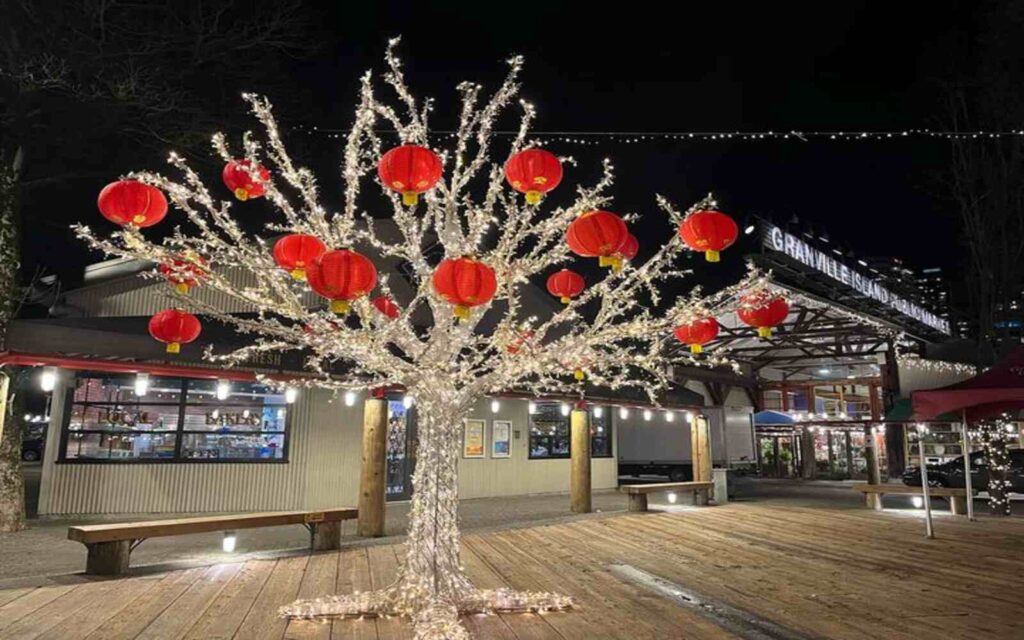 trees with full of lights and chinese lantern during the lunar fest celebrations in granville island 
