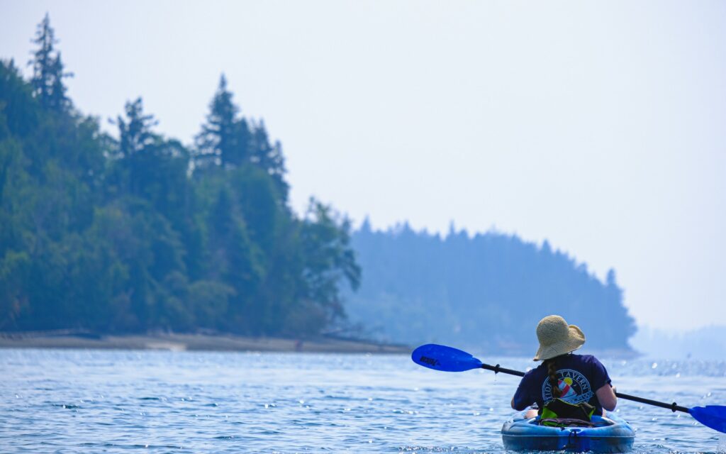 A woman enjoys a kayaking excursion 
in the Salish Sea while visiting Bellingham from Vancouver.