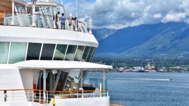 cruise passengers looking out at the vancouver coast mountains