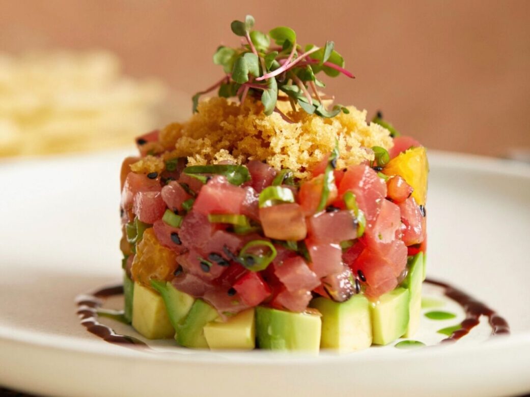 avocado and tuna stacked neatly with sauce on the side one the restaurants in stanley park